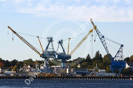 Cranes at the Portsmouth Naval Shipyard located on the Piscataqua River at Kittery, Maine, USA.