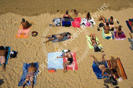 People sunbathe on the beach in the city of Donostia-San Sebastian, Guipuzcoa, Basque Country, Northern Spain.