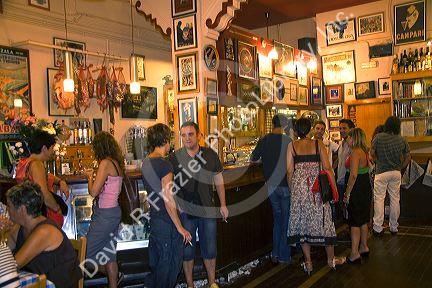 People socialize at a tavern in the city of Bilbao, Biscay, Basque Country, northern Spain.