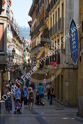 People shopping on a walking street in the city of Donostia-San Sebastian, Basque Country, Northern Spain.