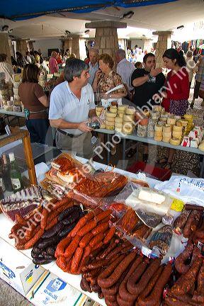 Vendors selling cheese and meats at an outdoor market in the town of Cangas de Onis, Asturias, northern Spain.