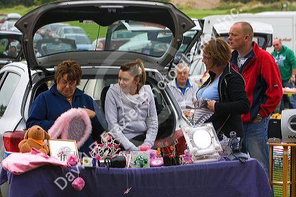People buy and sell household items at a car boot sale in the market town of Banbury, Oxfordshire, England.