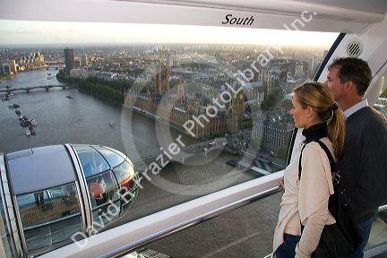 Tourists view the city of London from the London Eye, England.
