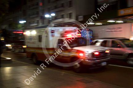 Ambulance in motion at night in Manhattan, New York City, New York, USA.