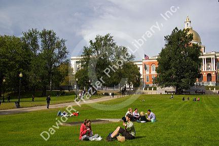People socialize on Boston Common in front of the Massachusetts State House located in the Beacon Hill neighborhood of Boston, Massachusetts, USA.