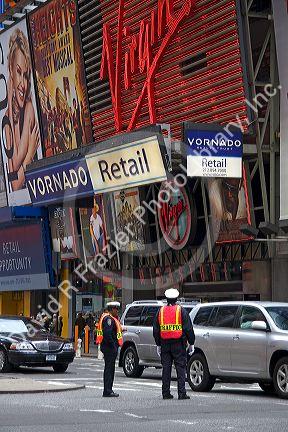 Traffic officers directing traffic in front of the Virgin Megastore in Times Square, Manhattan, New York City, New York, USA.