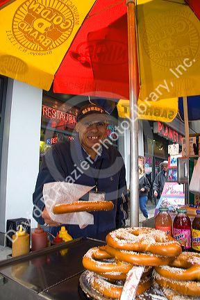 Street vendor selling pretzels in Times Square, Manhattan, New York City, New York, USA.
