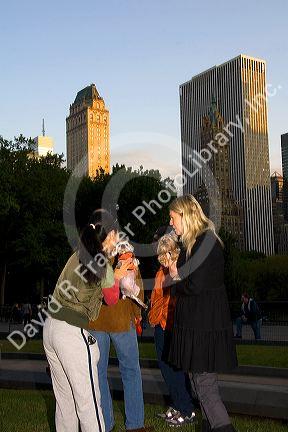 Dog owners socialize in Central Park, Manhattan, New York City, New York, USA.