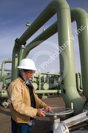 Operator turning a valve at a geothermal power plant in Malta, Idaho, USA. MR