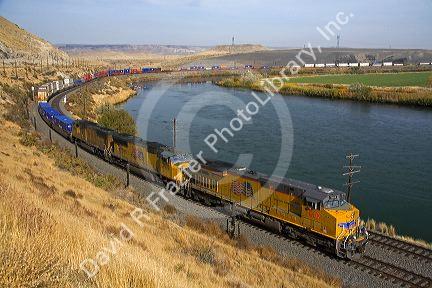 Union Pacific intermodal container train traveling along the Snake River in Elmore County, Idaho, USA.