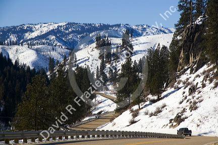 Truck traveling along South Fork of Payette River during winter in Boise County, Idaho.