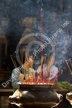 Incense burning at the Quan Am Pagoda, a famous Chinese temple in the Cholon district of Ho Chi Minh City, Vietnam.