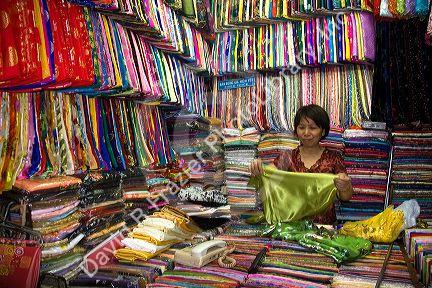 Vendors selling silk fabric in the Ben Thanh Market located in Ho Chi Minh City, Vietnam.