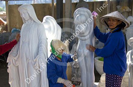 Vietnamese women carving marble sculptures at a shop in Ngu Hanh Son ward south of Da Nang, Vietnam.