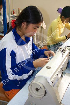 Disadvantaged Vietnamese youth learn to use a sewing machine at a vocational school named Kids First Vietnam in Dong Ha, Vietnam.