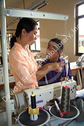 Disadvantaged Vietnamese youth learn to use a sewing machine at a vocational school named Kids First Vietnam in Dong Ha, Vietnam.