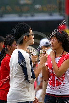 Vietnamese teens eat ice cream in Ho Chi Minh City, Vietnam.