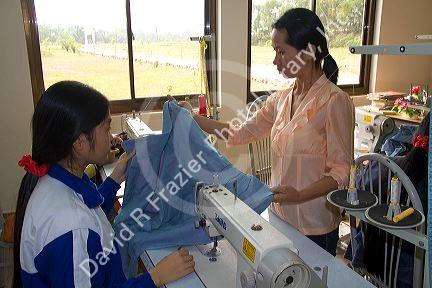 Disadvantaged Vietnamese youth learn to use a sewing machine at a vocational school named Kids First Vietnam in Dong Ha, Vietnam.