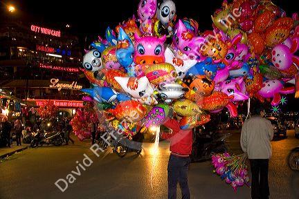 Street vendors selling colorful balloons for Tet in Hanoi, Vietnam.