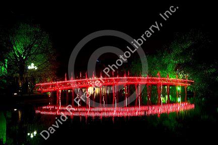 The Huc Bridge lit at night on Hoan Kiem Lake in Hanoi, Vietnam.
