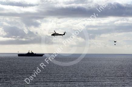 USS Bonhomme Richard Amphibious Assault Ship of the United States Navy being resupplied by helicopter in the Pacific Ocean near Camp Pendleton, California, USA.