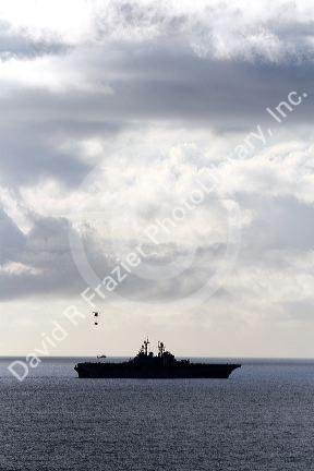 USS Bonhomme Richard Amphibious Assault Ship of the United States Navy being resupplied by helicopter in the Pacific Ocean near Camp Pendleton, California, USA.