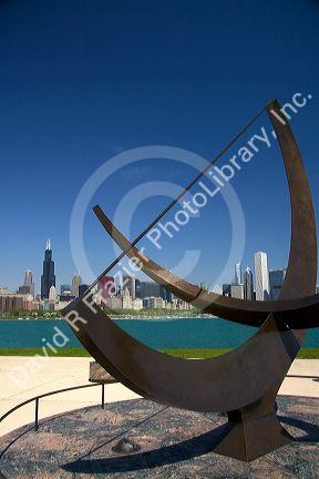 Cast bronze sundial sculpture named Man Enters the Cosmos by artist Henry Moore located on Lake Michigan outside the Adler Planetarium in Chicago, Illinois, USA.