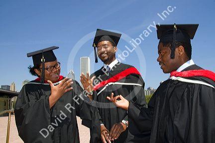 Multi ethnic college graduates celebrate the occasion in Grant Park, Chicago, Illinois, USA.