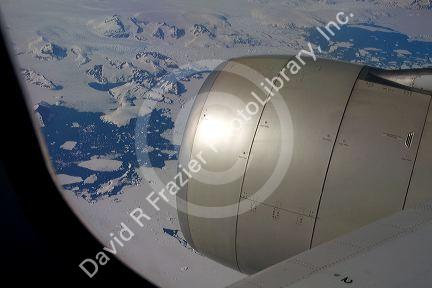 Aerial view of the glaciers and icebergs of Greenland from the window of an Airbus 330 passenger jet airliner.