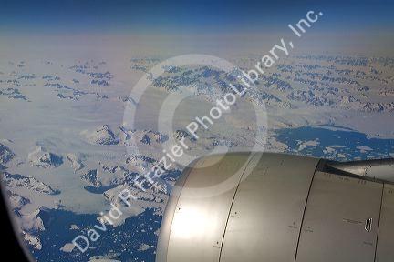 Aerial view of the glaciers and icebergs of Greenland from the window of an Airbus 330 passenger jet airliner.