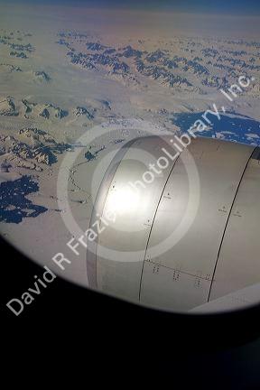 Aerial view of the glaciers and icebergs of Greenland from the window of an Airbus 330 passenger jet airliner.