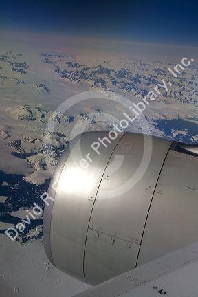 Aerial view of the glaciers and icebergs of Greenland from the window of an Airbus 330 passenger jet airliner.