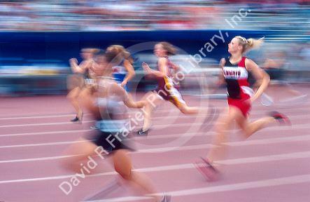 High school girls running in a track event.