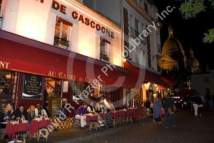Restaurant exterior and nightlife in the Montmartre District of Paris, France.