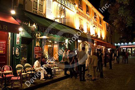 Restaurant exterior and nightlife in the Montmartre District of Paris, France.
