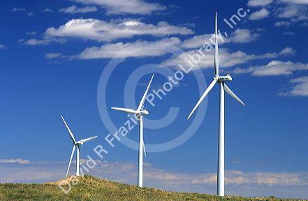 Three white windmills on a hillside in Kimball, Nebraska.