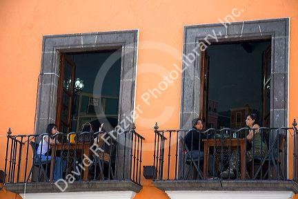 People dine on a restaurant balcony in the city of Puebla, Puebla, Mexico.