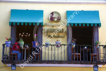 People dine on a restaurant balcony in the city of Puebla, Puebla, Mexico.