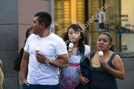 People eating ice cream cones on the street in Mexico City, Mexico.