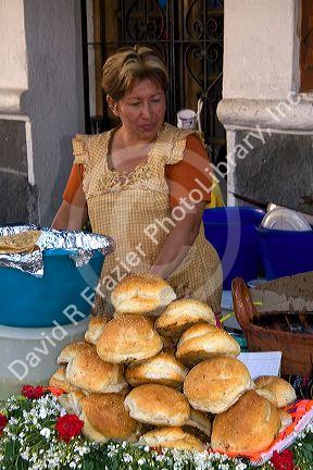 Woman selling bread at an outdoor market in the city of Puebla, Puebla, Mexico.
