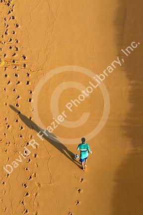 Person kicking a soccer ball on the beach at Acapulco, Guerrero, Mexico.