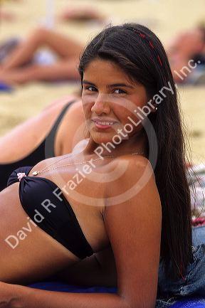 Chilean girl sunbathing on the beach at Vina del Mar, Chile.
