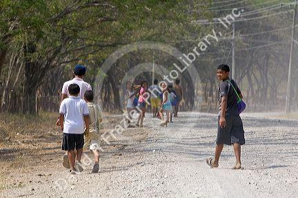 Costa Rican teens walk on a dirt road near the town of Nicoya, Costa Rica.