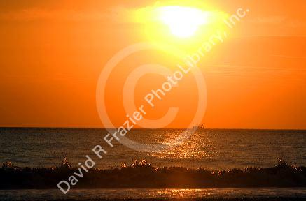 Fishing boat in the pacific ocean at sunset off the coast of Jaco, Costa Rica.