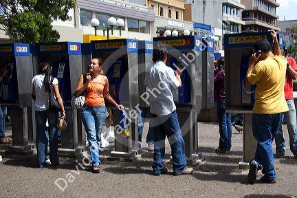 People using pay telephones in the city of San Jose, Costa Rica.