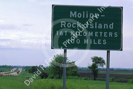 Road sign showing distance in kilometers and miles along Interstate 80 near Moline, Illinois, USA.