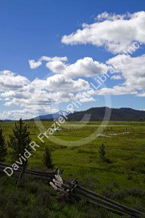Split rail fencing runs through a meadow near Stanley, Idaho, USA.