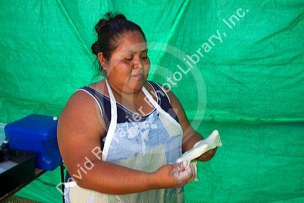 Native Pueblo woman making indian fry bread at Santo Domingo Pueblo, New Mexico, USA. MR
