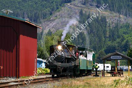Tourists ride behind a 1910 Heisler Steam Locomotive at Garibaldi, Oregon, USA.