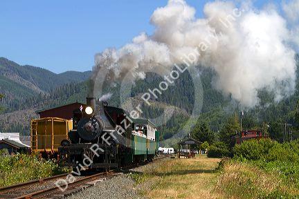 Tourists ride behind a 1910 Heisler Steam Locomotive at Garibaldi, Oregon, USA.